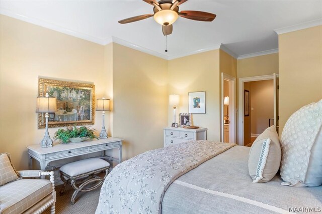 carpeted bedroom with ornamental molding and ceiling fan