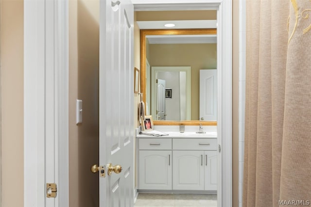 bathroom featuring tile floors and vanity with extensive cabinet space