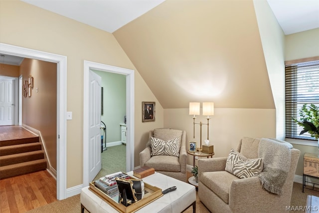 living area featuring vaulted ceiling and hardwood / wood-style floors