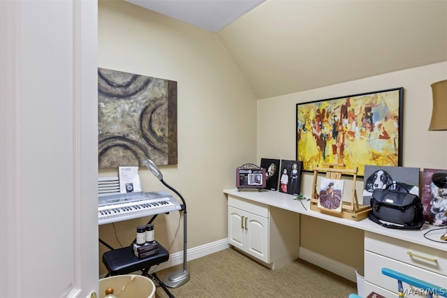 home office with light colored carpet, built in desk, and lofted ceiling