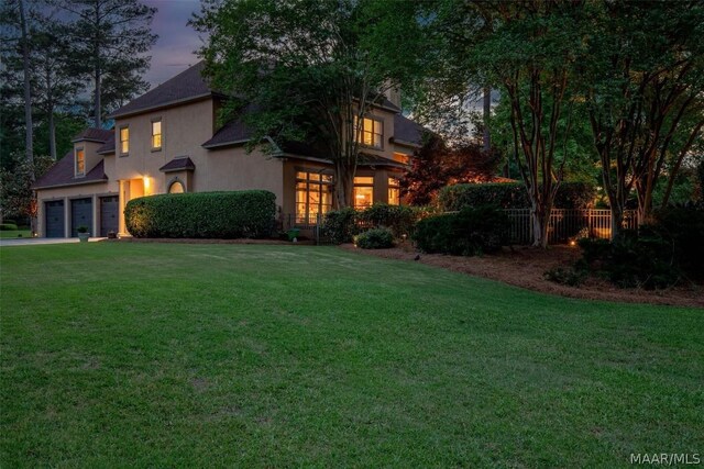 view of front of house featuring a yard and a garage