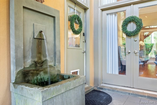 doorway to outside featuring tile flooring and french doors