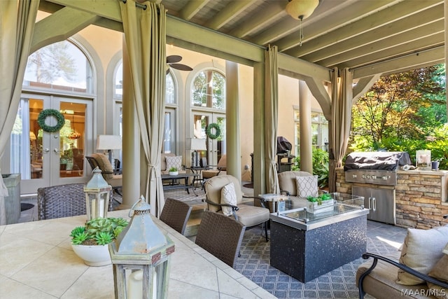 view of terrace with area for grilling, french doors, and exterior kitchen