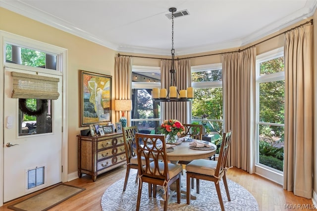 dining space with plenty of natural light, light hardwood / wood-style floors, and crown molding