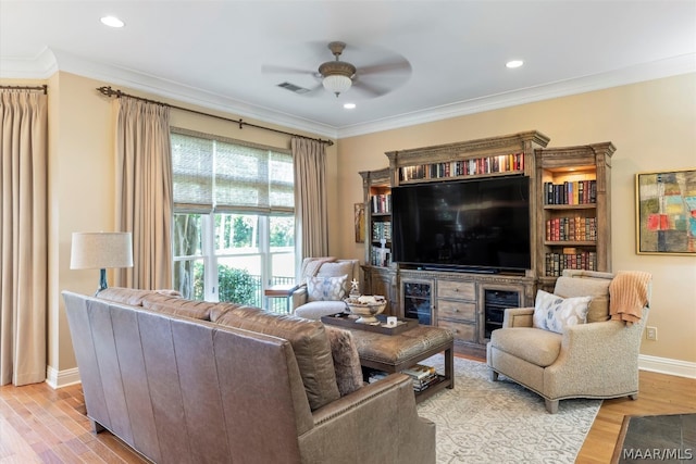 living room featuring ceiling fan, crown molding, and wood-type flooring