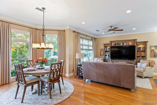 dining space featuring ceiling fan, light hardwood / wood-style flooring, and ornamental molding