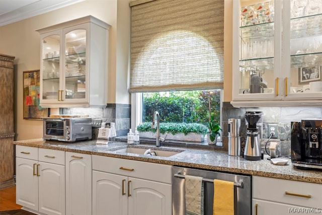 kitchen featuring hardwood / wood-style floors, stainless steel dishwasher, backsplash, sink, and stone countertops