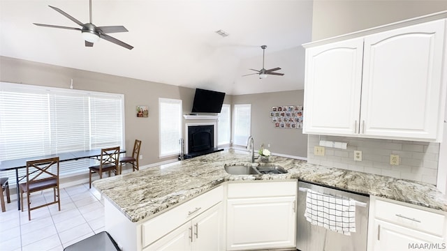 kitchen with ceiling fan, tasteful backsplash, dishwasher, sink, and white cabinetry