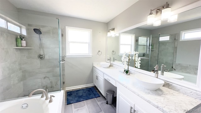 bathroom with oversized vanity, double sink, and plenty of natural light