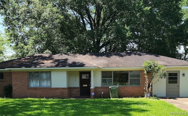 single story home featuring a front yard and brick siding