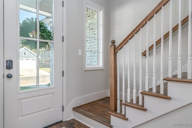 doorway featuring stairway, wood finished floors, and baseboards