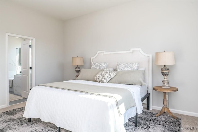 bedroom featuring carpet, connected bathroom, and baseboards