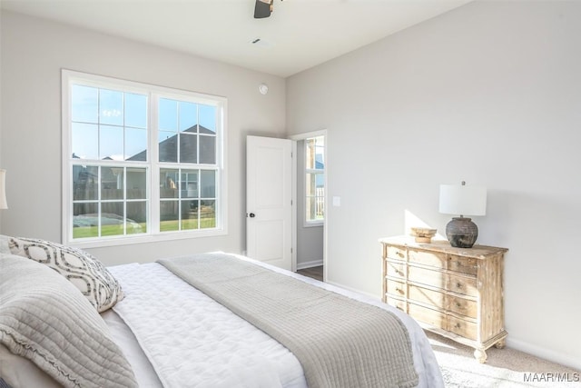 carpeted bedroom featuring ceiling fan and baseboards