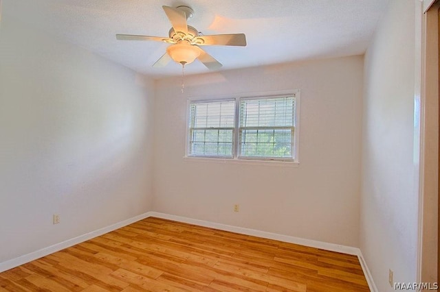 spare room with ceiling fan and light hardwood / wood-style floors