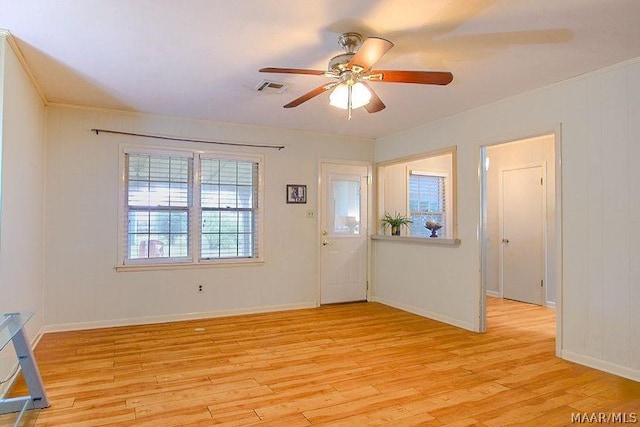 spare room with ceiling fan and light wood-type flooring