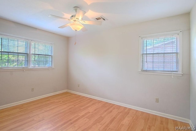 empty room with ceiling fan and light wood-type flooring