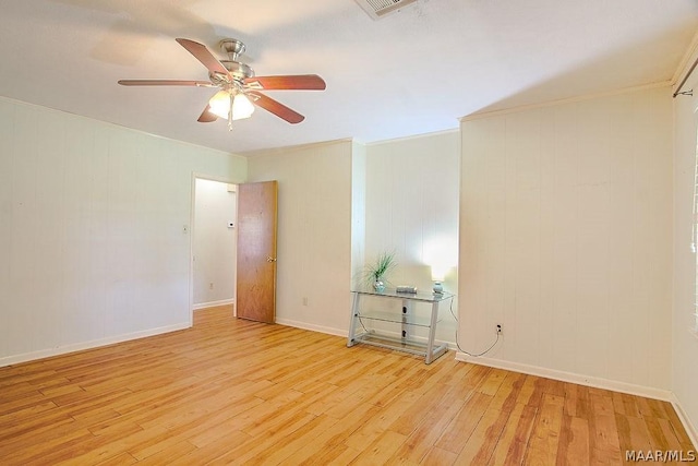 spare room featuring light wood-type flooring and ceiling fan