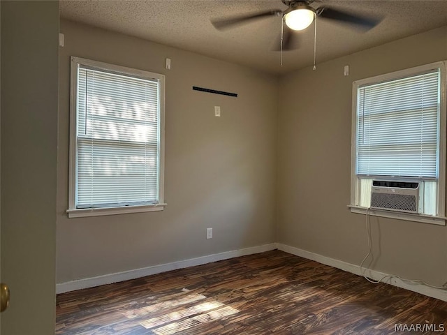 empty room featuring dark hardwood / wood-style flooring, a textured ceiling, ceiling fan, and cooling unit