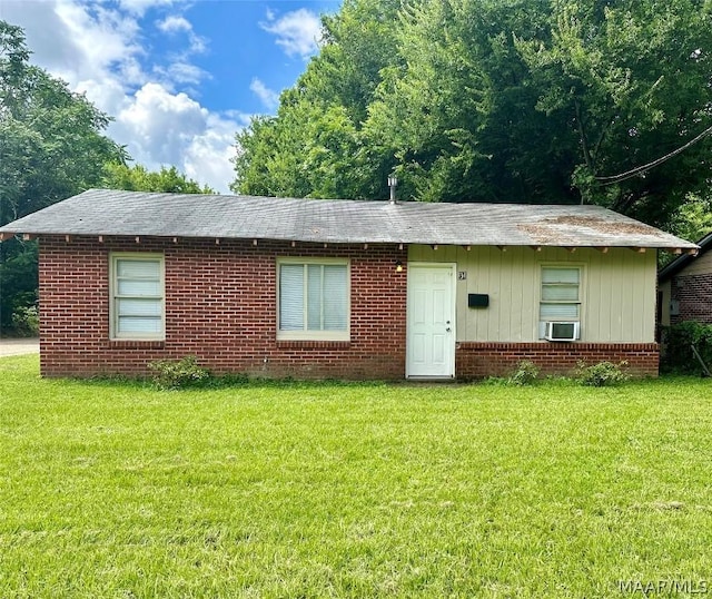 single story home with cooling unit and a front lawn