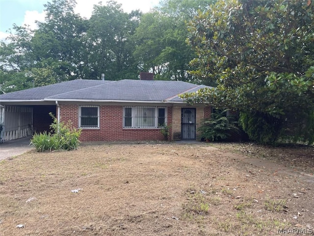 single story home featuring a carport