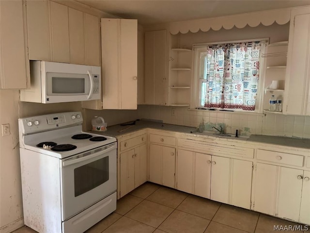 kitchen featuring white cabinets, light tile patterned flooring, white appliances, and sink