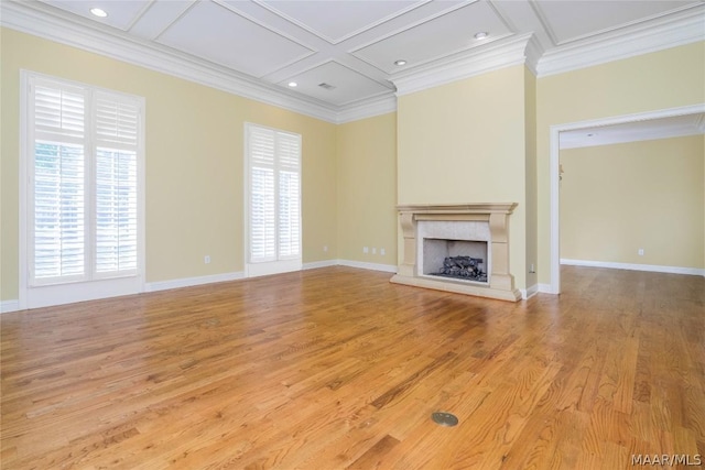 unfurnished living room with coffered ceiling, beamed ceiling, crown molding, a fireplace, and hardwood / wood-style flooring