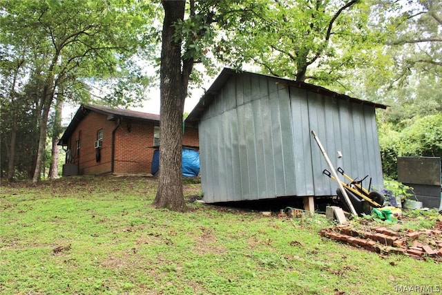 view of outbuilding featuring a yard