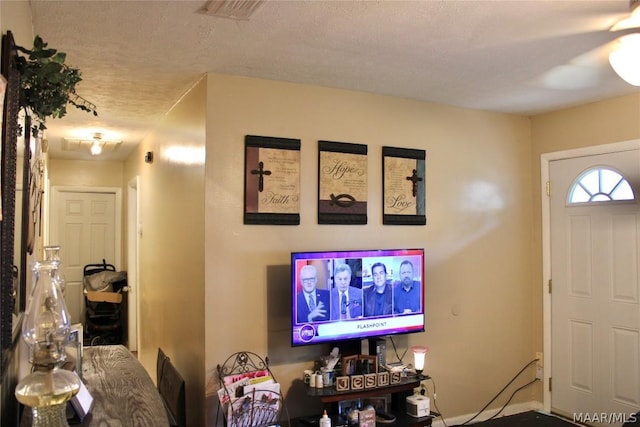 entryway with a textured ceiling