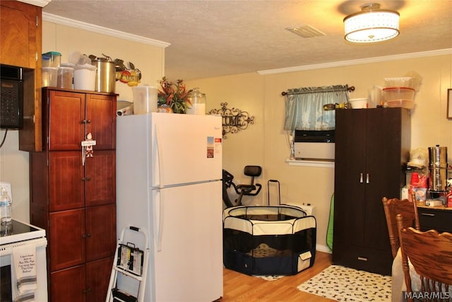 kitchen featuring light hardwood / wood-style flooring, ornamental molding, a textured ceiling, and white refrigerator