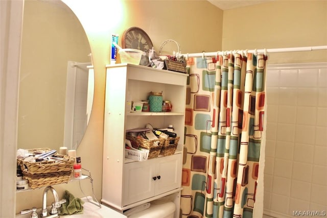 bathroom featuring walk in shower and sink