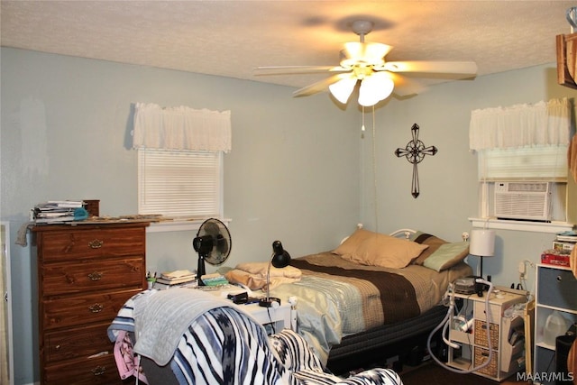 bedroom featuring ceiling fan, cooling unit, and a textured ceiling