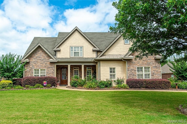 craftsman-style home featuring a front lawn