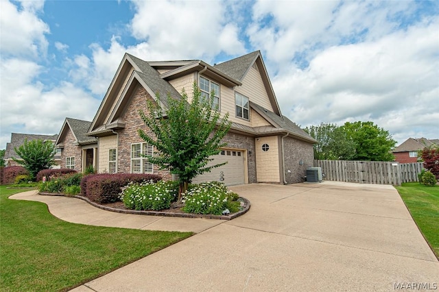 view of property exterior with a garage, a yard, and central AC unit