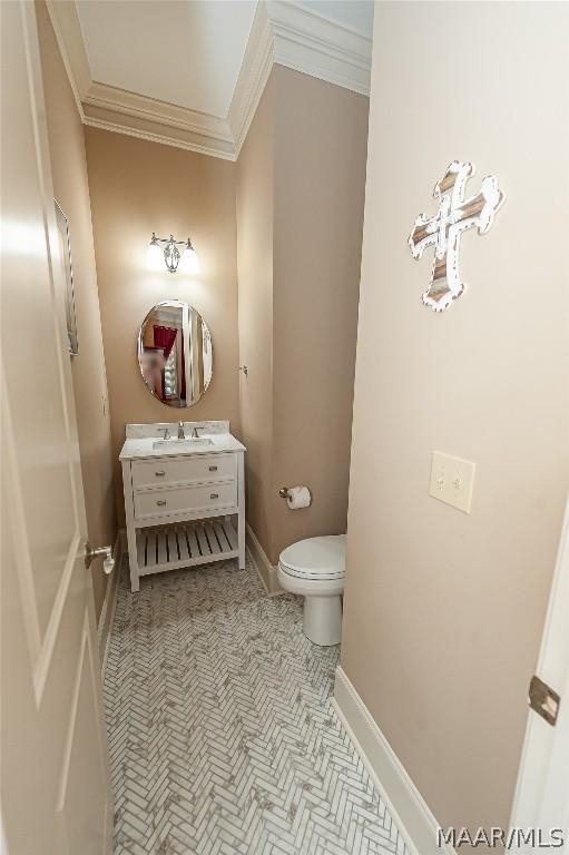 bathroom featuring vanity, crown molding, and toilet