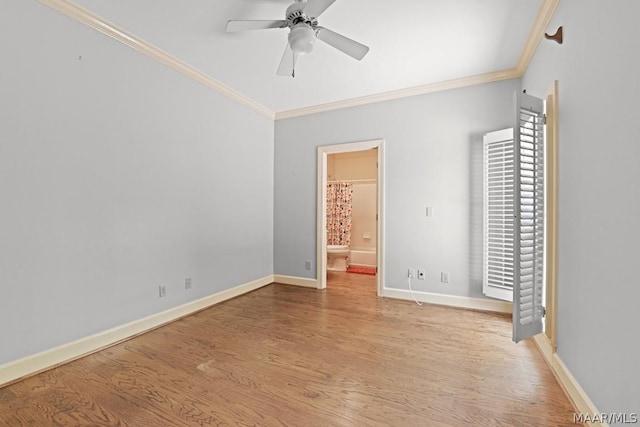 unfurnished bedroom featuring ensuite bath, ceiling fan, crown molding, and light hardwood / wood-style floors