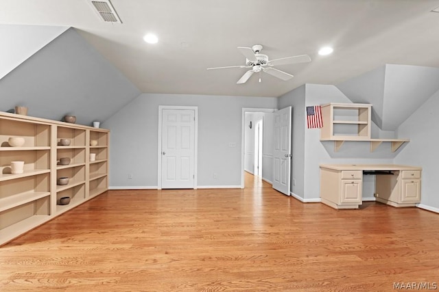 additional living space featuring built in shelves, ceiling fan, light hardwood / wood-style flooring, and vaulted ceiling