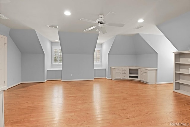 additional living space with ceiling fan, vaulted ceiling, and light wood-type flooring