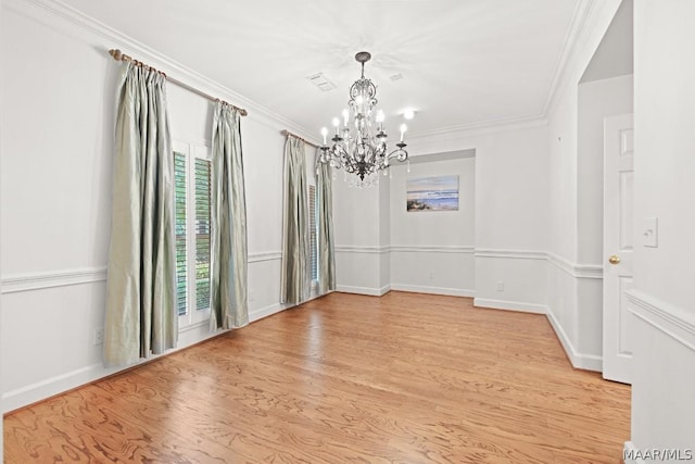 interior space featuring crown molding, light hardwood / wood-style flooring, a chandelier, and plenty of natural light