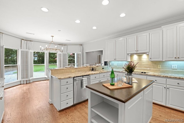 kitchen with dishwasher, a center island, decorative light fixtures, and white cabinetry