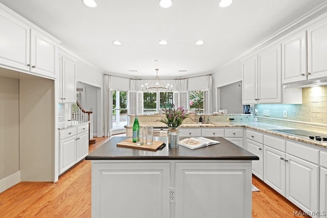 kitchen featuring a center island, light hardwood / wood-style flooring, and white cabinetry