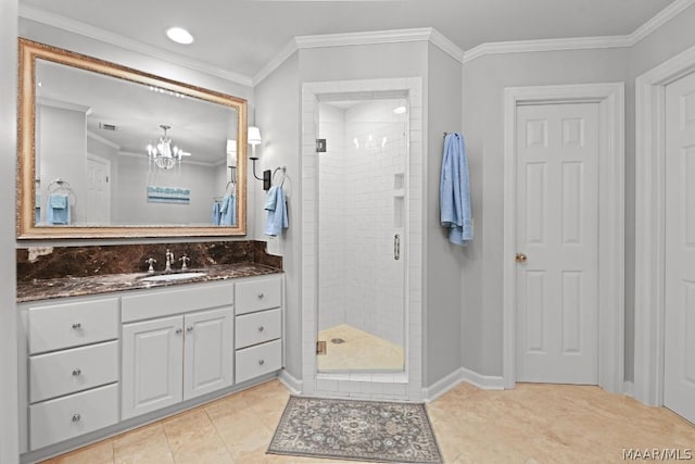 bathroom with tile patterned flooring, vanity, a shower with door, and crown molding