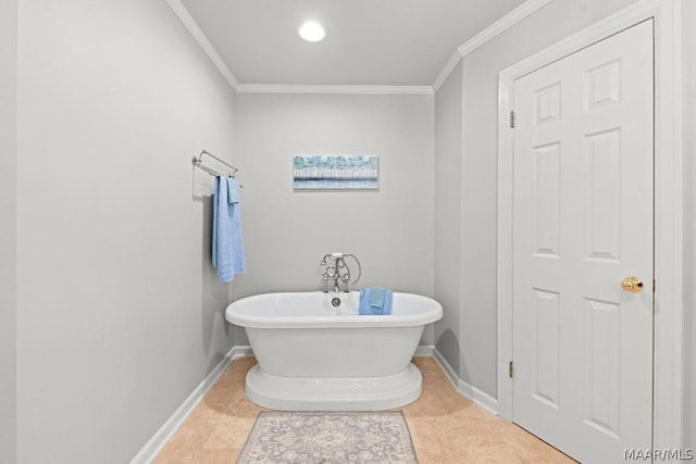 bathroom featuring tile patterned floors, crown molding, and a tub