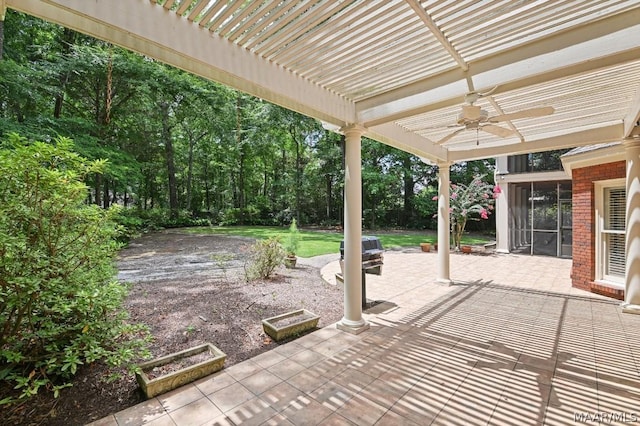 view of patio featuring a pergola, ceiling fan, and a sunroom