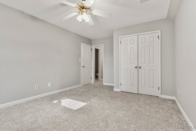 unfurnished bedroom with a closet, ceiling fan, and light carpet