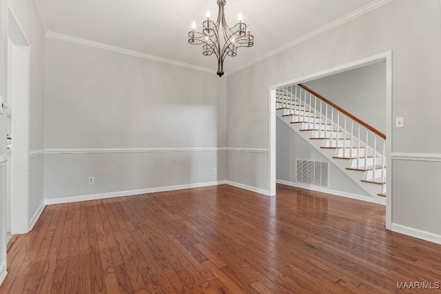 spare room with hardwood / wood-style floors, a chandelier, and ornamental molding