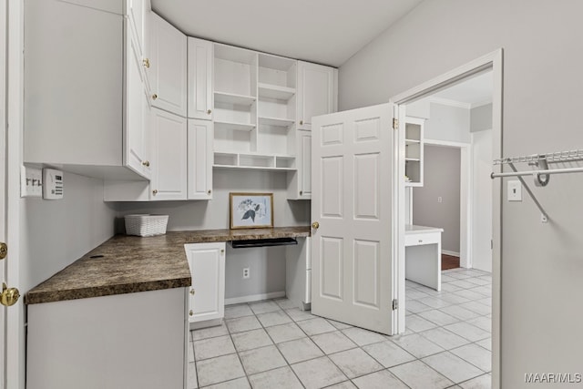 kitchen featuring white cabinetry and light tile patterned flooring