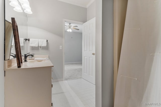 bathroom featuring tile patterned flooring, vanity, ceiling fan, and ornamental molding