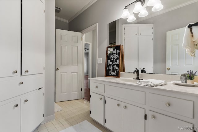 bathroom featuring crown molding, vanity, and tile patterned floors