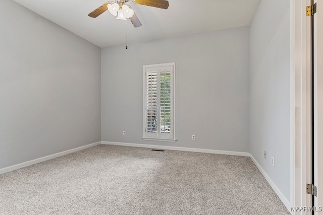 empty room with ceiling fan and carpet