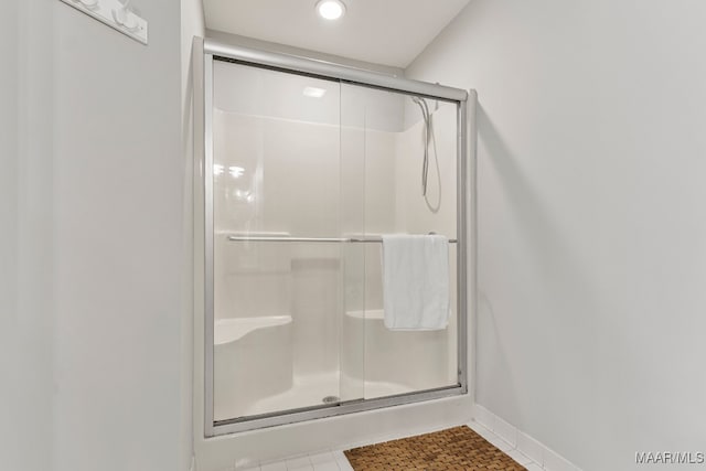 bathroom with tile patterned floors and walk in shower